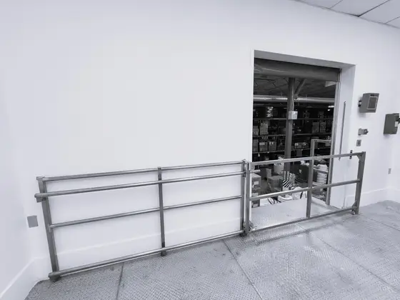 Stainless steel safety guardrail and swing gate installed by Wetzel Welding in a clean processing room