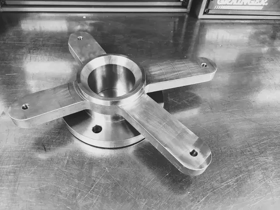 Precision-machined stainless steel four-arm mounting hub fabricated by Wetzel Welding